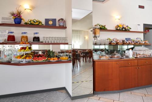 a restaurant with a buffet with food on display at Hotel Atlantic in Rimini