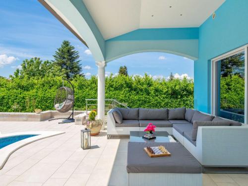 a patio with a couch and a table at Holiday Home Villa Gabriel - LBN417 by Interhome in Labin