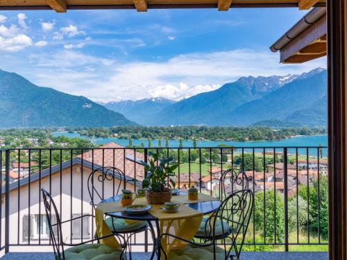 a balcony with a table and chairs and a view of mountains at Apartment Azalea - GLA103 by Interhome in Gera Lario