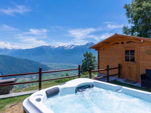 a hot tub with a view of mountains at Holiday Home La tana del lupo by Interhome in Albonico