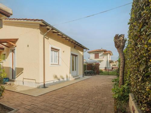 a house with a brick driveway next to a building at Holiday Home Manuela by Interhome in Marina di Pietrasanta