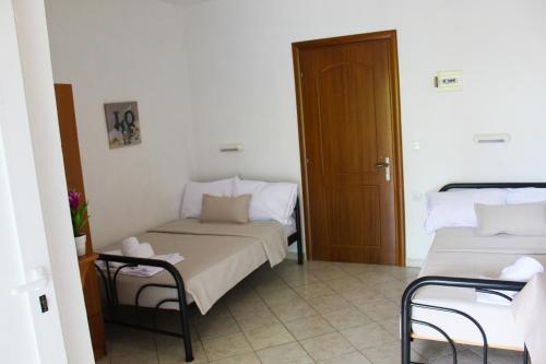 a room with two beds and a door in it at VILLA BORA in Leptokaria