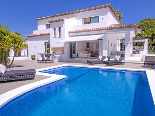 une villa avec une piscine en face d'une maison dans l'établissement VACATION MARBELLA I Villa Lina, Golf Valley, Jacuzzi, Close to the Marina, à Marbella