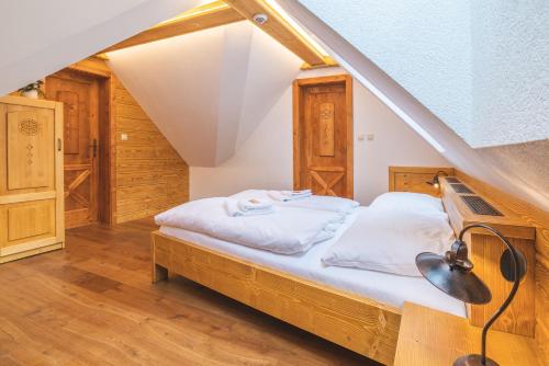 a bedroom with a bed with a lamp on it at Salaš Syrex in Zázrivá
