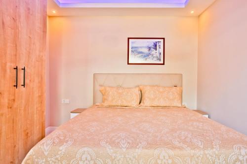 a bedroom with a bed and a wooden door at Nur Suites & Hotels in Kalkan