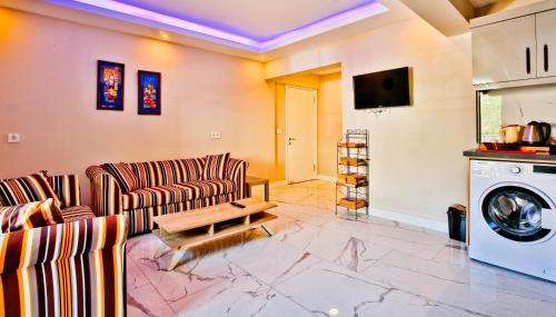 a living room with two couches and a washing machine at Nur Suites & Hotels in Kalkan