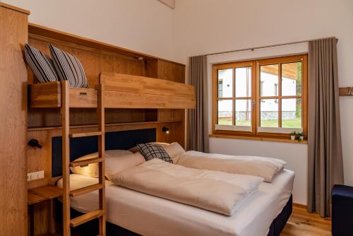 a bedroom with a bunk bed and a bunk bed at Luxury Chalets Gradenbach near Schladming in Haus im Ennstal