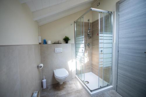 a bathroom with a toilet and a glass shower at Le PALME in Parma