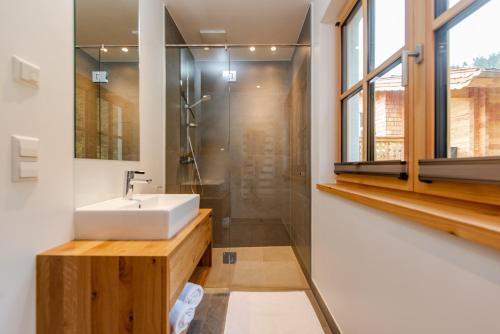 a bathroom with a sink and a shower at Luxury Chalets Gradenbach near Schladming in Haus im Ennstal