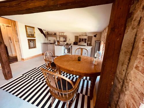 a kitchen with a wooden table and chairs at Gutshaus Klein kussewitz in Klein Kussewitz