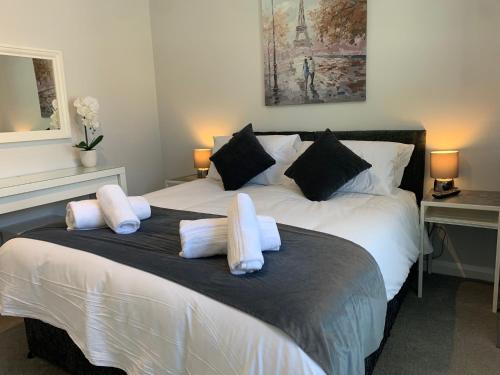 a bedroom with a large bed with white pillows at Eclipse Apartment No 3 in Newmarket