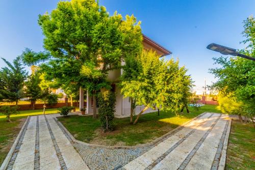 a house with a tree in front of it at VISTA Villa in Belek