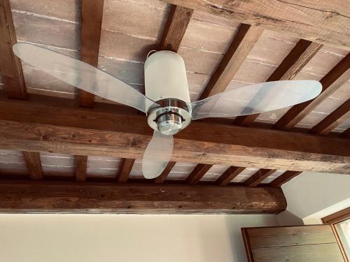 a ceiling fan hanging from a wooden ceiling at Parco Ducale Country House in Urbania