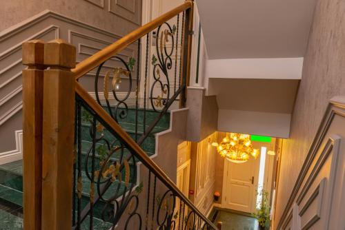 a staircase with a chandelier in a house at Begonville Mansion Oldcity in Istanbul