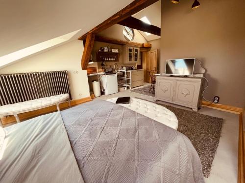 a bedroom with a large bed and a kitchen at Gutshaus Klein kussewitz in Klein Kussewitz