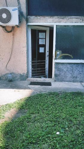 an open door to a building with a window at Apartment Ruža in Kladovo