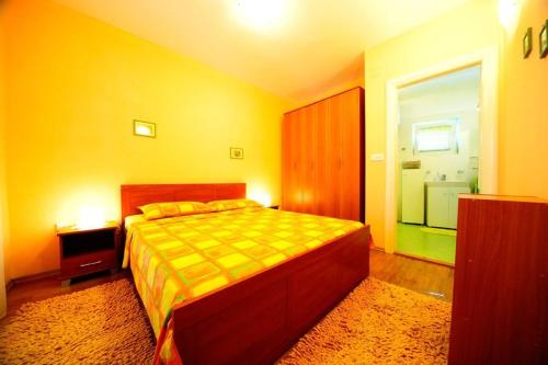 a bedroom with a bed and a bathroom with a window at Villa with garden and pool Supetar Island Brac in Supetar