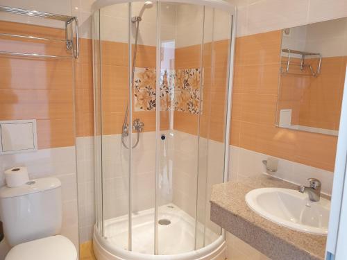 uma casa de banho com um chuveiro, um WC e um lavatório. em Sunny Day Club Hotel em Sunny Beach