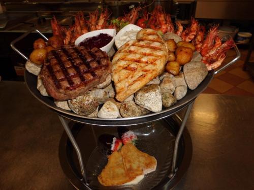 a plate of food with seafood and other foods at Rezidence u Jezera in Jeseník