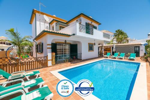 a villa with a swimming pool and a house at Riad Serpa Galé - Luxury, private pool, AC, wifi, 5 min from the beach in Guia