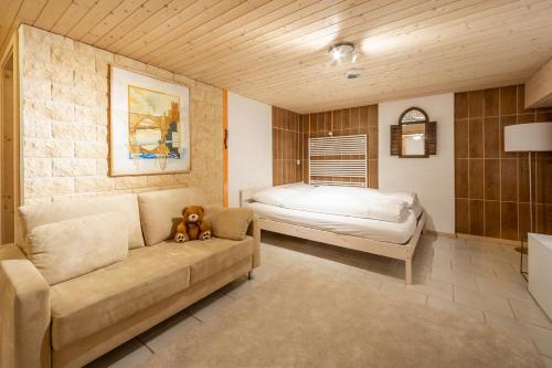 a living room with a couch and a bed at Cristallina II in Laax