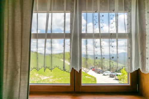 a window with a view of a road at Salaš Syrex in Zázrivá