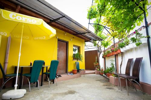 a restaurant with a table and chairs and an umbrella at Casa Lili in Mangalia