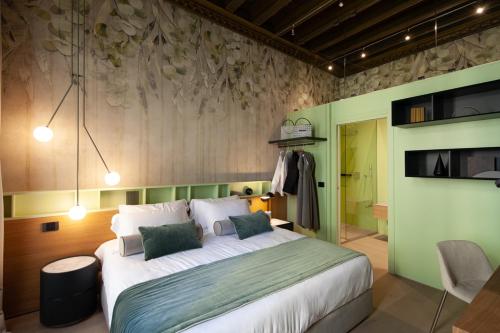 a bedroom with a large bed and a green wall at Palazzo Pianca in Venice