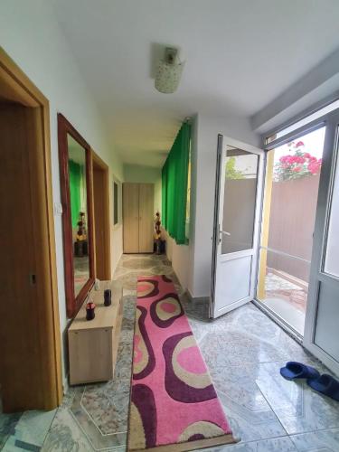 a hallway with a rug in the middle of a room at Casa Lili in Mangalia