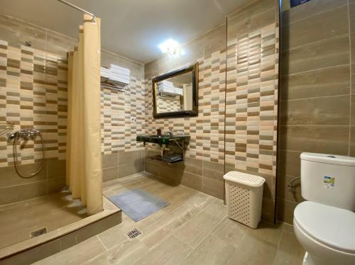 a bathroom with a shower and a toilet and a sink at ECO VILLA OLYMPUS with sauna in Kariá