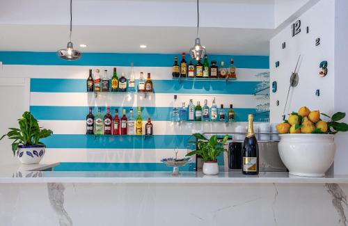 a bar with a blue and white striped wall at Hotel Angelina in Sant'Agnello