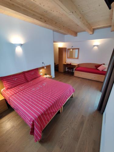 a large bedroom with a large bed in a room at Bio Agritur al Bait in Spormaggiore