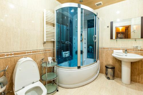a bathroom with a shower and a toilet and a sink at Tsaghkadzor Homeland in Tsaghkadzor