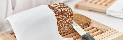 a loaf of bread on a cutting board with a knife at Hotel Hottingen in Zürich
