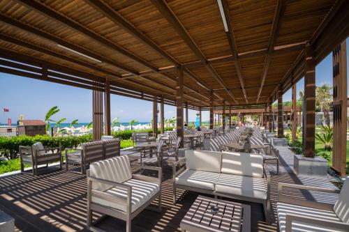 a group of chairs and tables on a patio at Seaden Quality Resort & Spa Ultra All Inclusive in Side