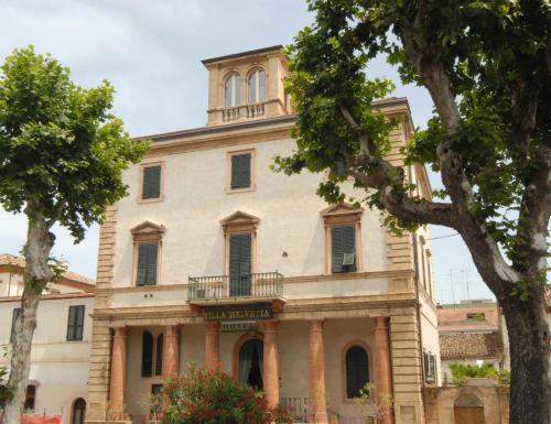 an old building with a tower on top of it at Villa Helvetia in Grottammare
