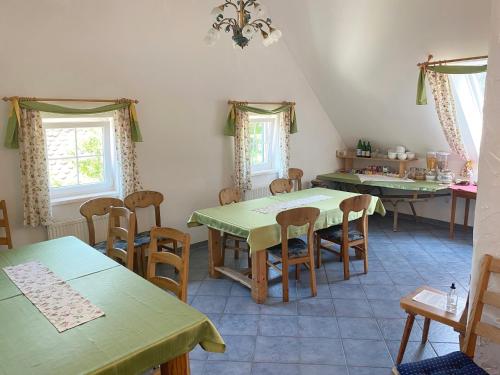 a kitchen with tables and chairs in a room at Farmer-Rabensteiner in Bad Gams