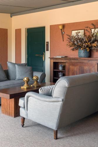 a living room with a couch and a coffee table at The Kefalari Suites in Athens