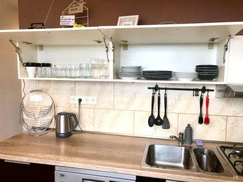 a kitchen counter with a sink and utensils at Apartment Tatry - spacious 3BD, Netflix & fast internet in Tatranska Strba