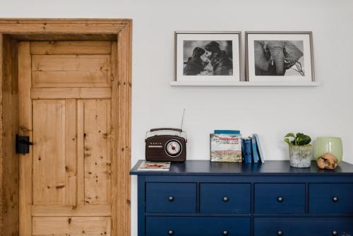 a blue dresser with a radio on top of it at Sommers Hotel Altes Posteck in Reichenbach im Vogtland