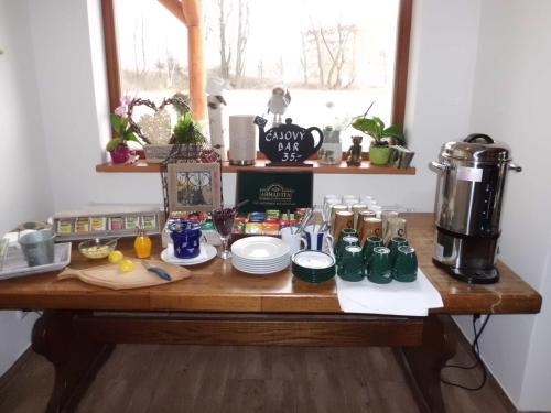 a table with food and a coffee maker on it at Rezidence u Jezera in Jeseník