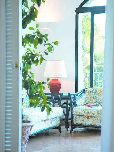 a room with two chairs and a table with a lamp at Covo Dei Saraceni in Positano