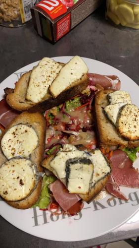 a plate of food with sandwiches on a table at le Mas d'Hubert in LʼIsle-sur-la-Sorgue