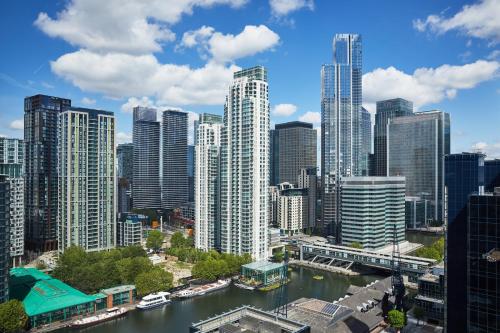 a view of a city with a river and buildings at ARK Canary Wharf in London