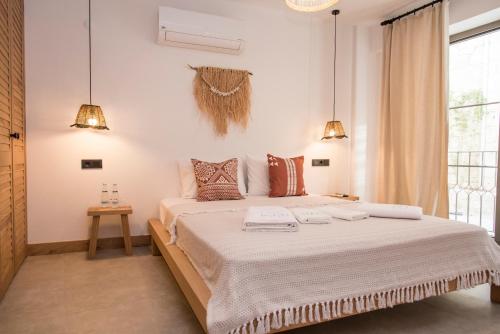 a bedroom with a large bed with two towels on it at LUPA ALAÇATI in Çeşme