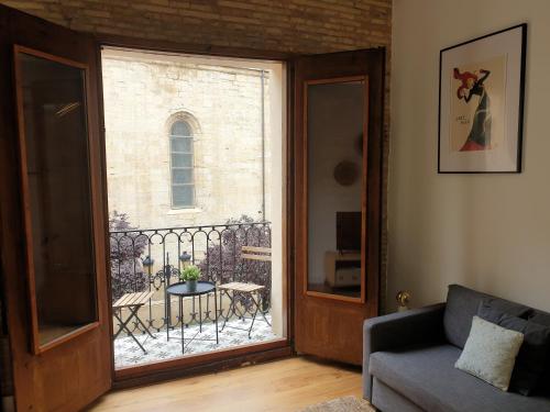 a living room with a door open to a balcony at El Secreto de Portales in Logroño