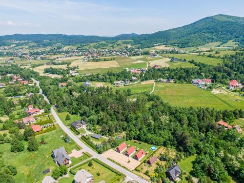an aerial view of a village in the mountains at Domki Pod Czarnym Groniem in Rzyki