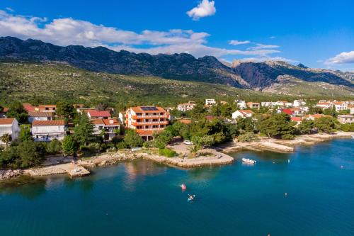 
a large body of water surrounded by mountains at Pansion Kiko in Starigrad
