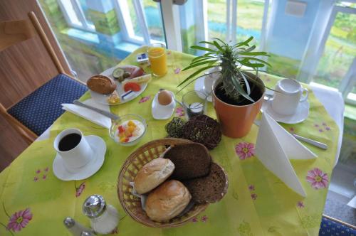 a table with a plate of breakfast food on it at Hotel Reuterhof in Darmstadt