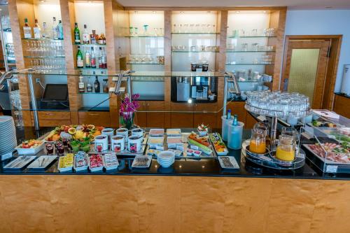 a buffet of food and drinks on a table at Schlosspark Hotel in Berlin
